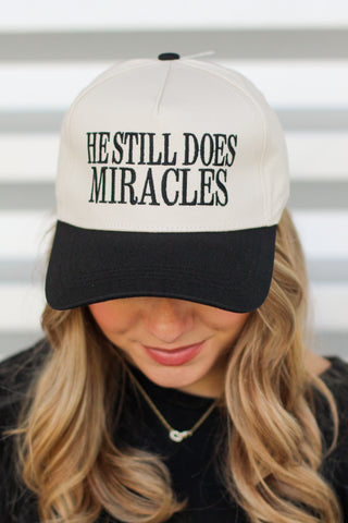 He Does Miracles Trucker Hat